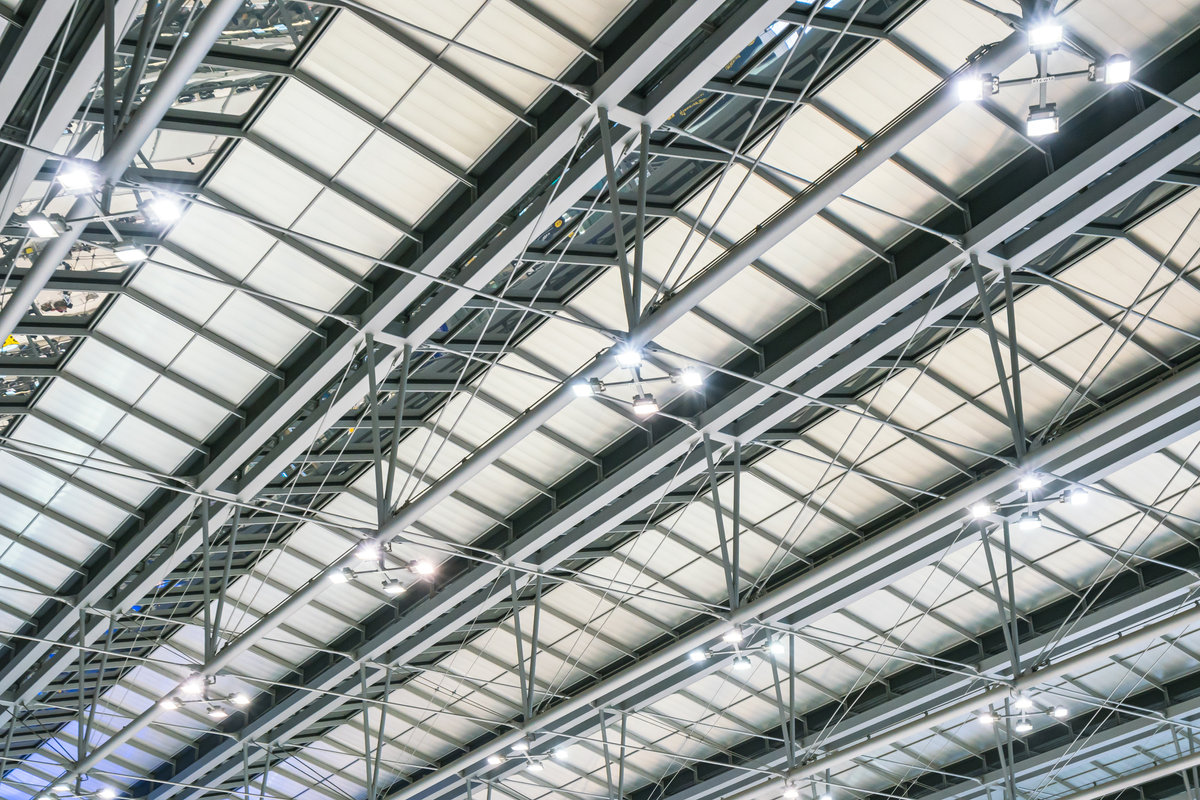 Interior of a large warehouse with racked materials and equipment.