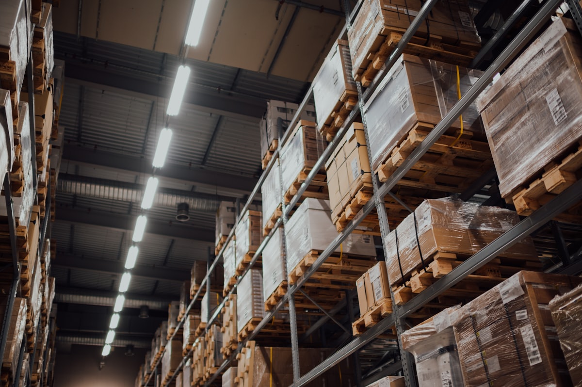 Warehouse pallet racking stacked with tracked construction materials, ready for procurement.