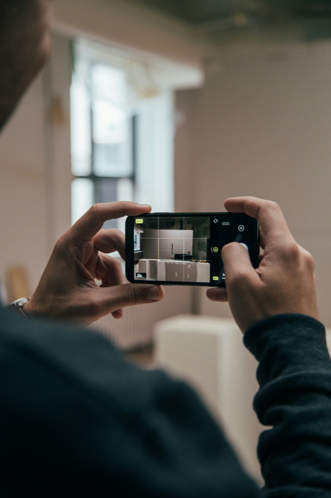 A contractor captures a jobsite on a phone, the everyday moment Quoto Build turns into structured insight.